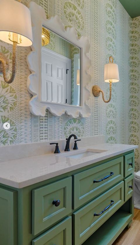 Custom green bathroom vanity with scalloped mirror