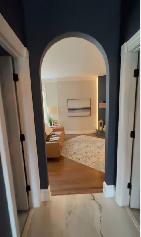 Architectural archway between rooms in dark navy paint