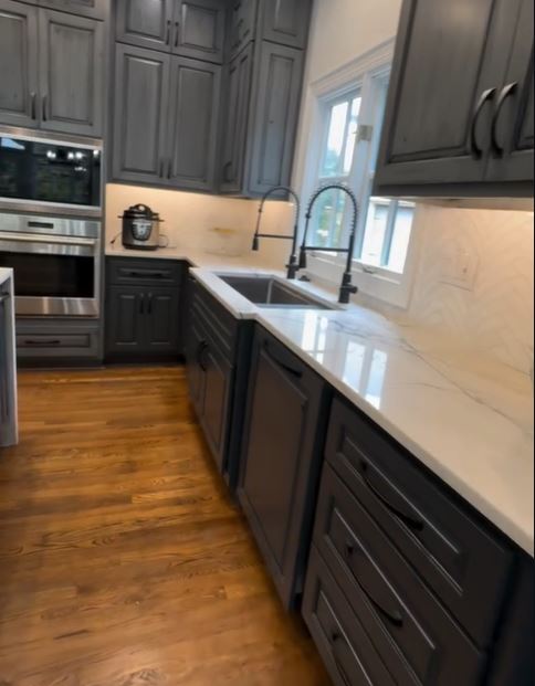Distressed gray cabinetry with marble countertop