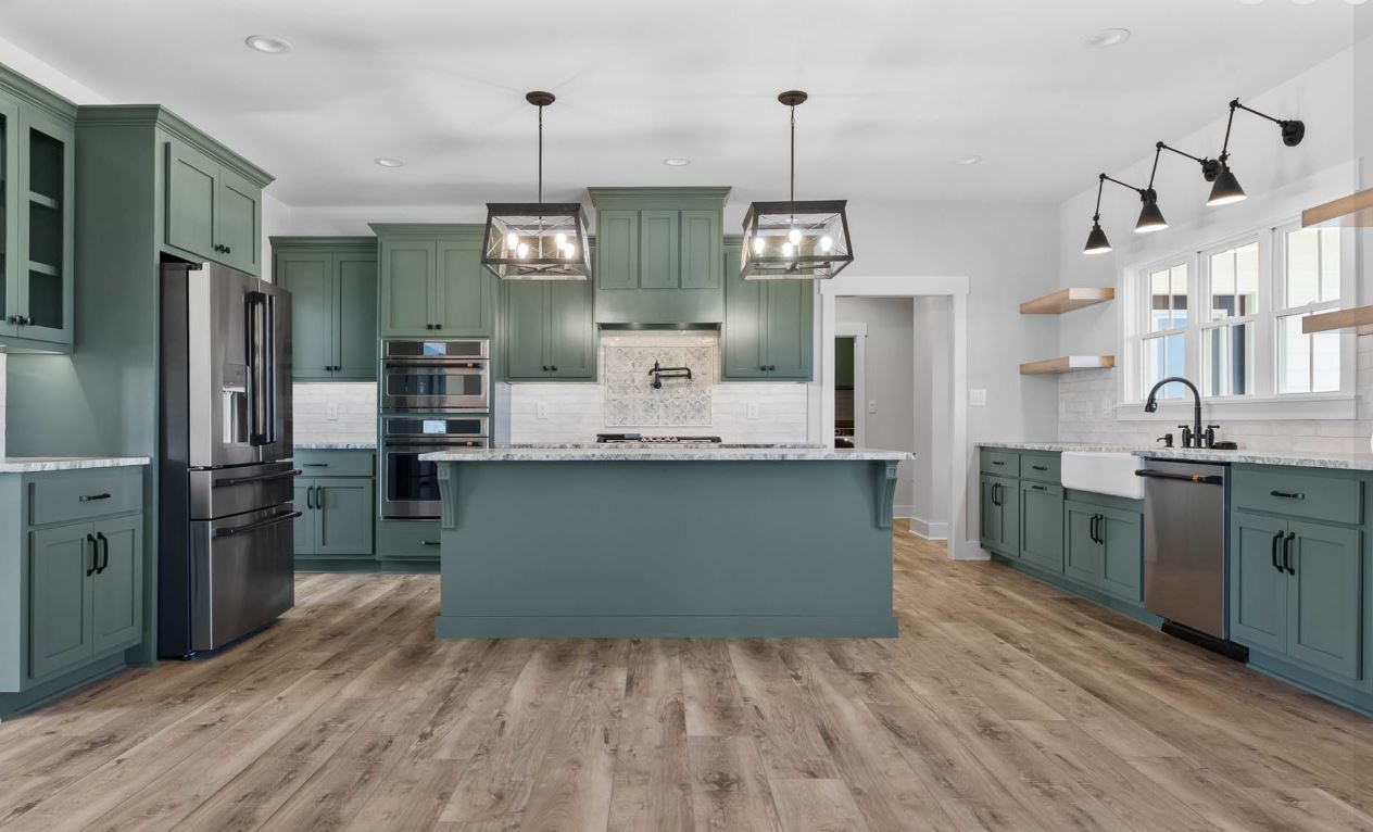 Sage green kitchen with vintage-inspired pendant lighting