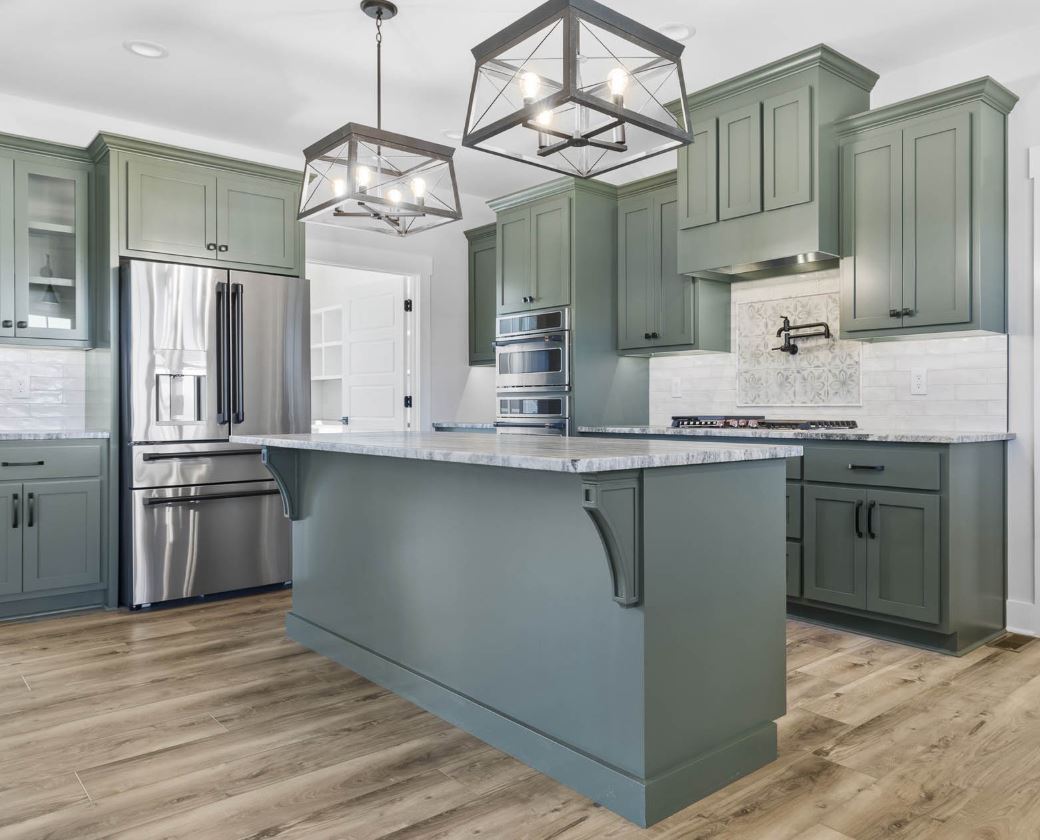 Wide view of sage green kitchen showing full layout and floor plan