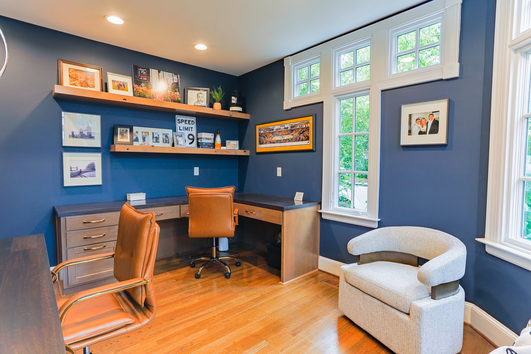 Navy home office with custom wood built-in shelving